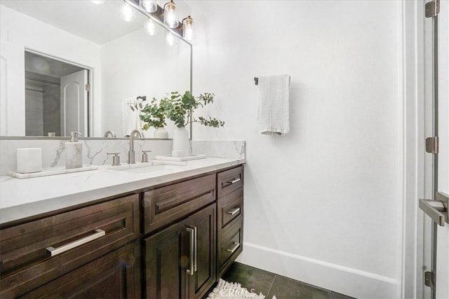 bathroom featuring tile patterned flooring, baseboards, and vanity