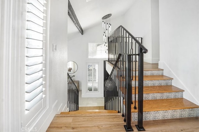 stairs with lofted ceiling and wood finished floors