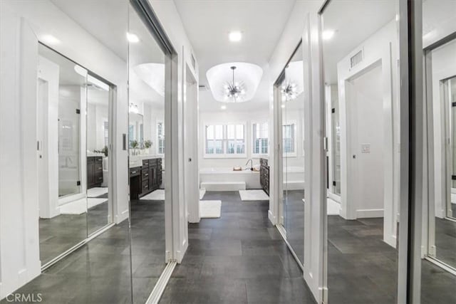 interior space with visible vents and an inviting chandelier