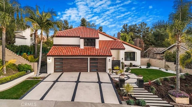 mediterranean / spanish-style home featuring a garage, fence, a tiled roof, driveway, and stucco siding