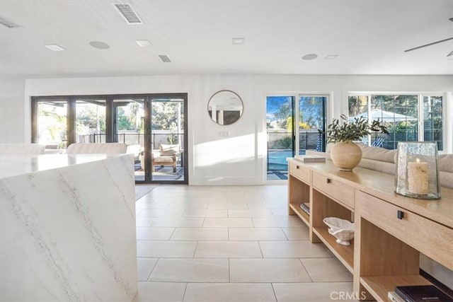 interior space featuring light tile patterned floors and visible vents