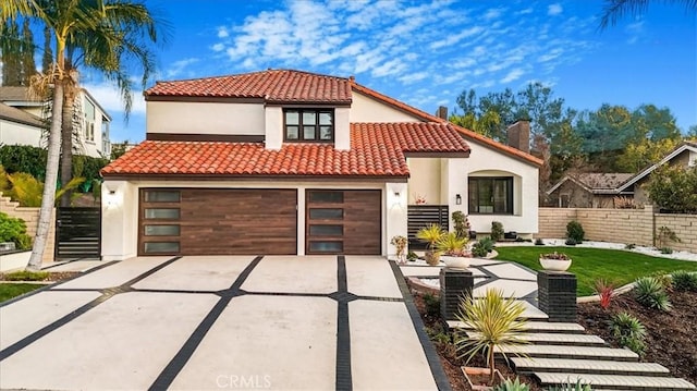 view of front of property featuring stucco siding, concrete driveway, fence, a garage, and a tiled roof