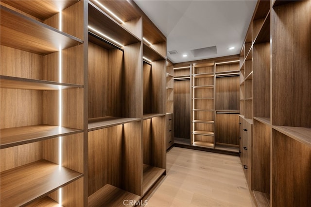 walk in closet with light wood-type flooring and visible vents