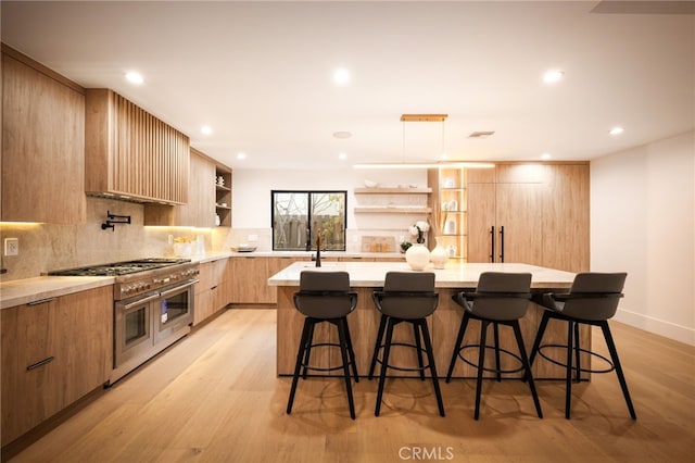 kitchen with range with two ovens, open shelves, backsplash, modern cabinets, and light wood-type flooring