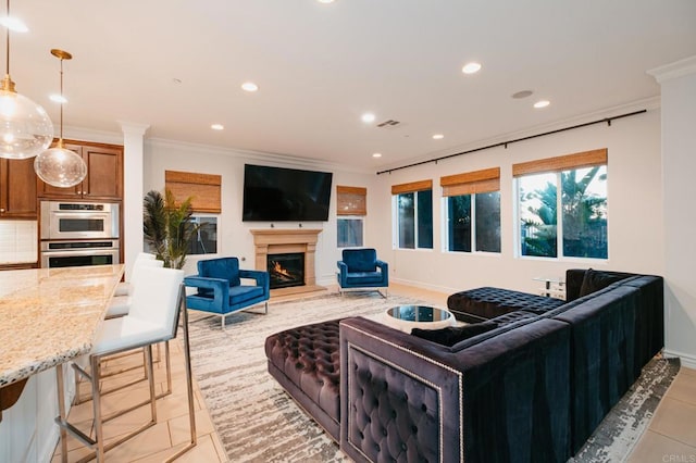 living area with a warm lit fireplace, visible vents, crown molding, and recessed lighting