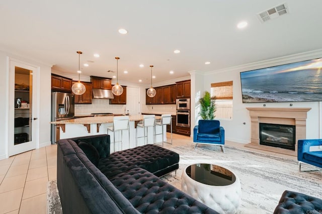 living area featuring light tile patterned floors, recessed lighting, visible vents, and crown molding