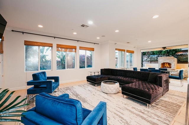 living room with visible vents, a fireplace, baseboards, and recessed lighting