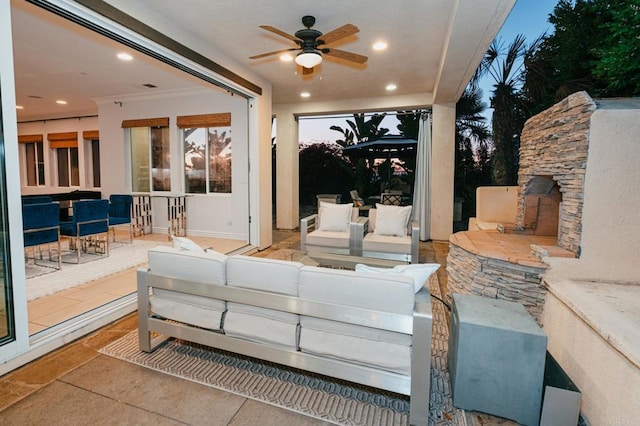 view of patio featuring a ceiling fan and an outdoor living space with a fireplace