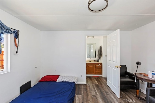 bedroom featuring dark wood-style floors, a sink, and baseboards