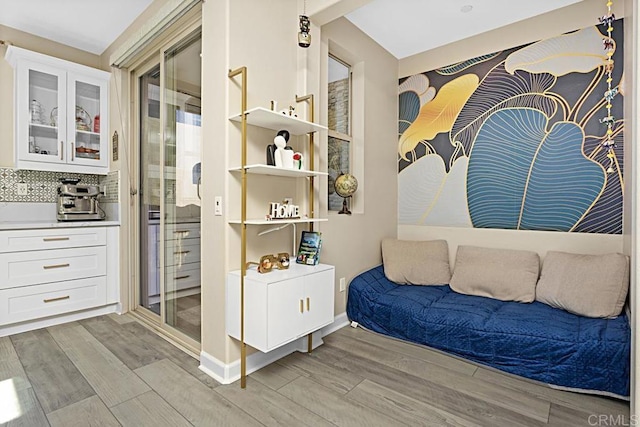 sitting room with baseboards and light wood-style floors