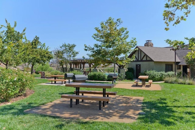 view of community featuring a yard and a patio