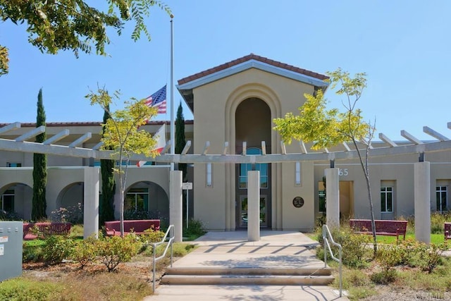 view of front of home featuring a tile roof and stucco siding