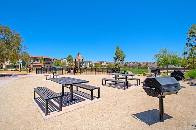 view of home's community featuring playground community and fence