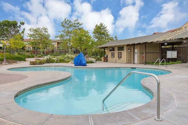 pool featuring a patio area and fence