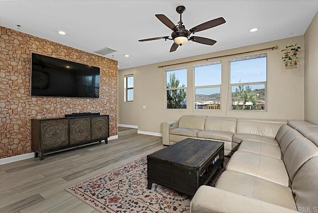 living area featuring recessed lighting, visible vents, baseboards, and wood finished floors