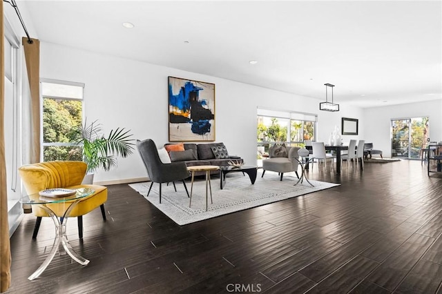 living area with a wealth of natural light, wood finished floors, and recessed lighting