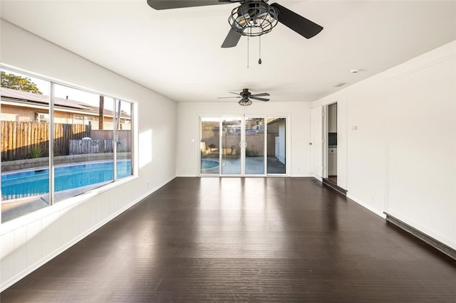 empty room featuring visible vents, baseboards, and wood finished floors