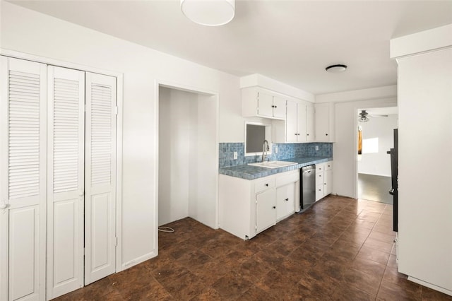 kitchen featuring decorative backsplash, ceiling fan, a sink, white cabinetry, and stainless steel dishwasher