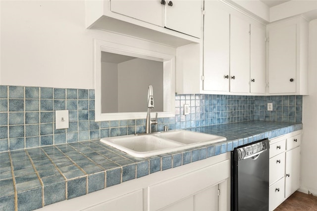 kitchen featuring a sink, white cabinetry, black dishwasher, tile counters, and decorative backsplash