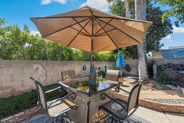 view of patio featuring a fenced backyard and outdoor dining area