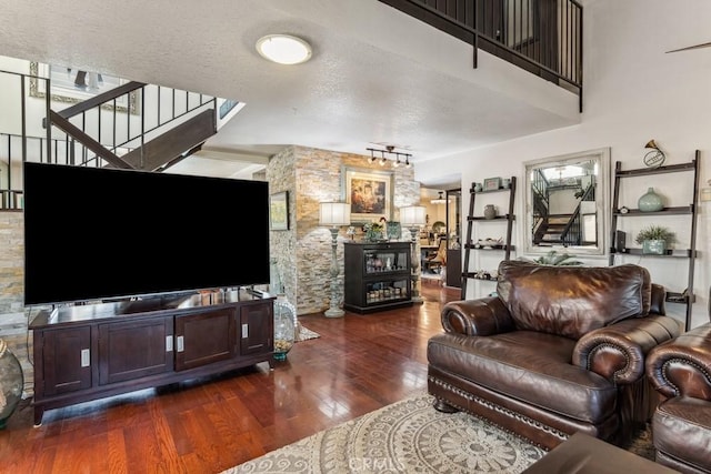 living room featuring a healthy amount of sunlight, a textured ceiling, and wood finished floors