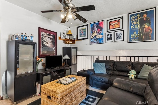 living area with a textured ceiling and ceiling fan