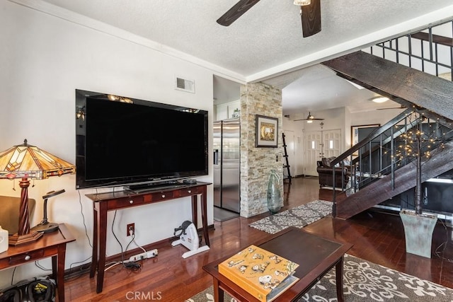 living area featuring visible vents, stairway, lofted ceiling with beams, a textured ceiling, and wood finished floors