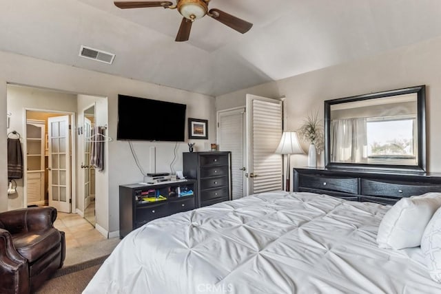 bedroom featuring lofted ceiling, visible vents, baseboards, a ceiling fan, and carpet