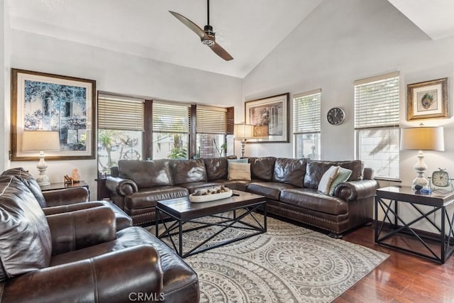 living area with high vaulted ceiling, plenty of natural light, wood finished floors, and a ceiling fan