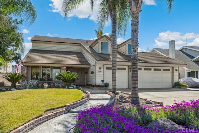 view of front of home with a garage, concrete driveway, a front lawn, and a tile roof