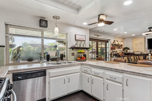 kitchen featuring appliances with stainless steel finishes, a sink, white cabinetry, and tasteful backsplash