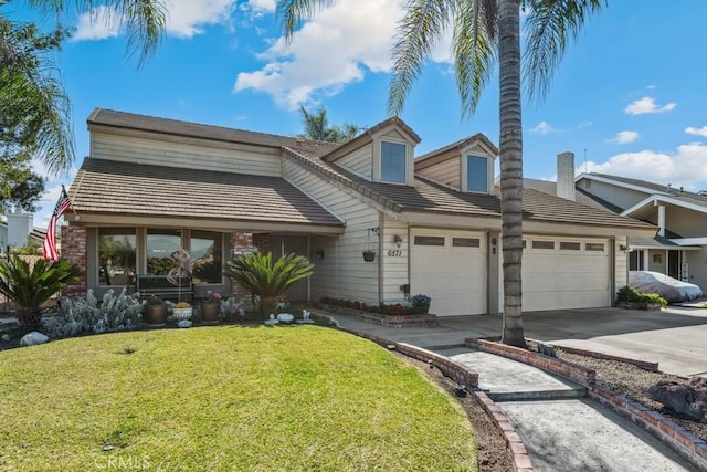 view of front of house with driveway, an attached garage, a tile roof, and a front yard