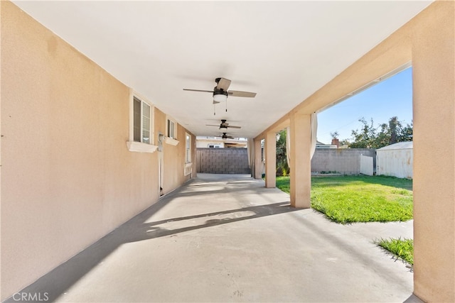 view of patio with ceiling fan and fence