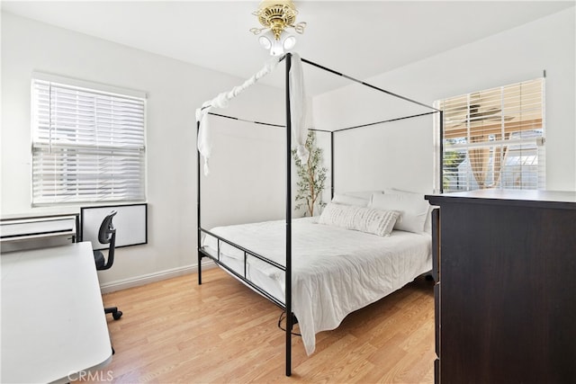 bedroom featuring light wood-style flooring and baseboards