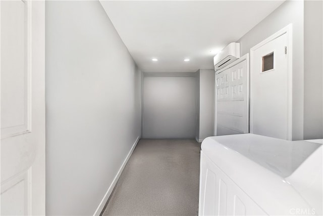 hallway featuring washer / dryer, baseboards, a wall mounted air conditioner, carpet flooring, and recessed lighting