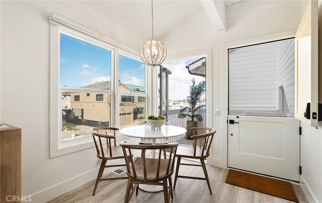 207 E Edgewater Ave Unit A, Newport Beach, CA 92661 - dining room with vaulted ceiling, baseboards, an inviting chandelier, and light wood-style floors