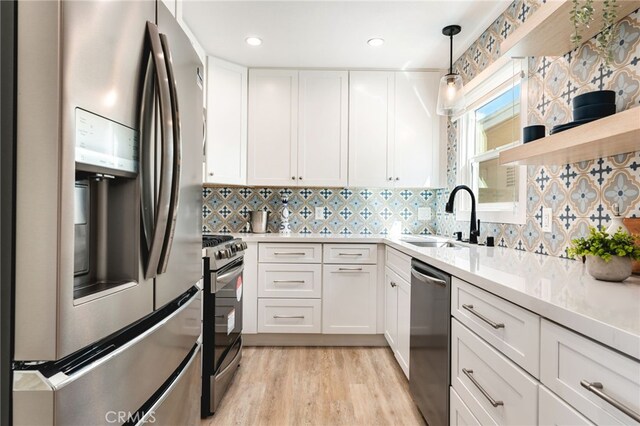 207 E Edgewater Ave Unit A, Newport Beach, CA 92661 - kitchen featuring white cabinets, stainless steel appliances, light countertops, and a sink