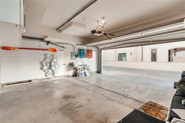 207 E Edgewater Ave Unit A, Newport Beach, CA 92661 - garage featuring electric panel and a garage door opener