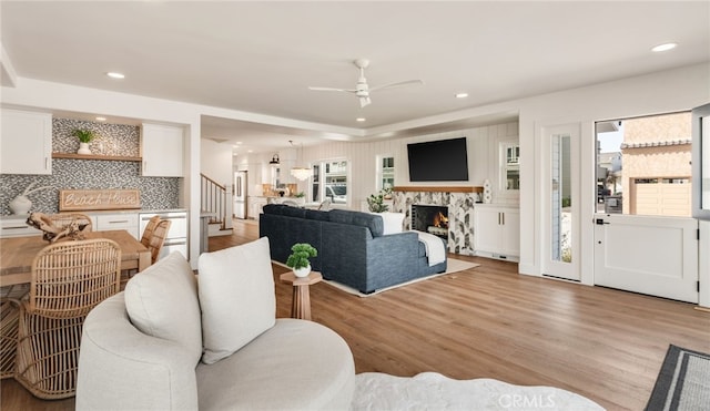 207 E Edgewater Ave Unit A, Newport Beach, CA 92661 - living area with a ceiling fan, stairs, light wood-type flooring, and a healthy amount of sunlight