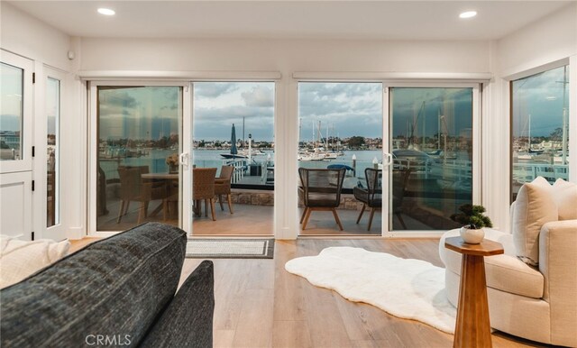 207 E Edgewater Ave Unit A, Newport Beach, CA 92661 - interior space featuring recessed lighting, wood finished floors, a water view, and access to outside