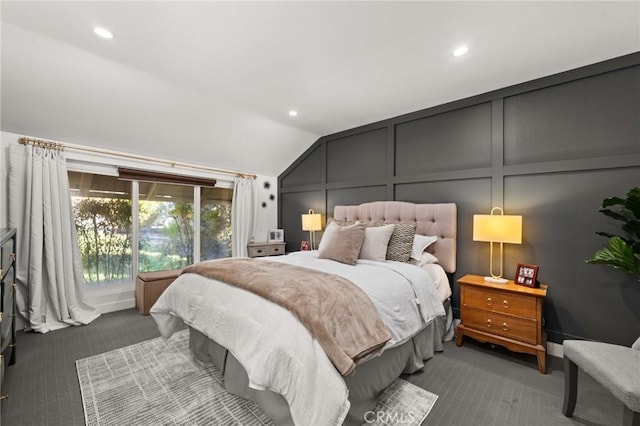 bedroom with carpet floors, recessed lighting, vaulted ceiling, and a decorative wall