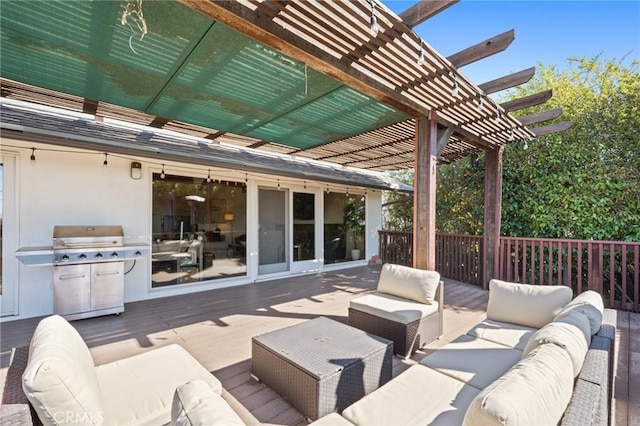 view of patio with area for grilling, outdoor lounge area, a wooden deck, and a pergola