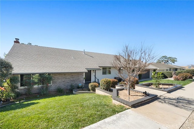 ranch-style home with concrete driveway, a chimney, an attached garage, a front yard, and brick siding