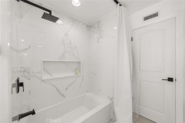 bathroom with shower / tub combo and visible vents