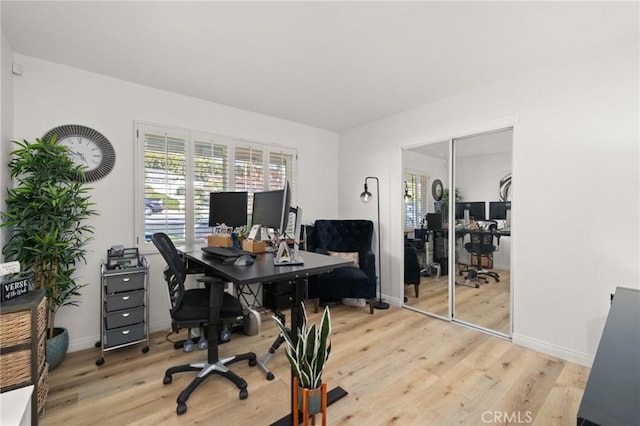 office with baseboards and light wood-style floors