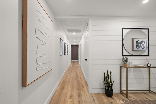 hallway with light wood-type flooring, visible vents, baseboards, and recessed lighting