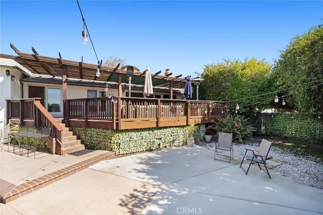 view of patio with fence and a wooden deck