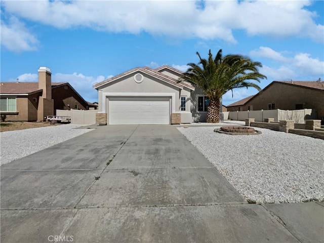 ranch-style house featuring a garage, driveway, fence, and stucco siding