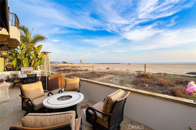 view of patio / terrace with a fire pit and a water view