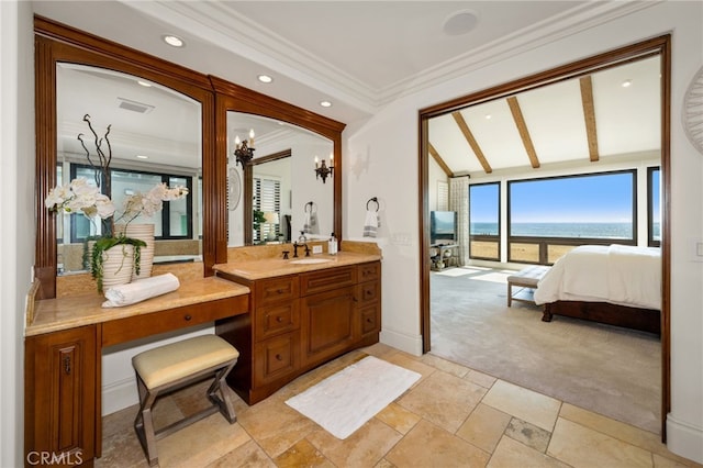 ensuite bathroom featuring vanity, visible vents, lofted ceiling, crown molding, and ensuite bath